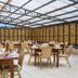 Kilimo Grand Resort Nairobi outdoor dining area with set tables under a glass-roof canopy