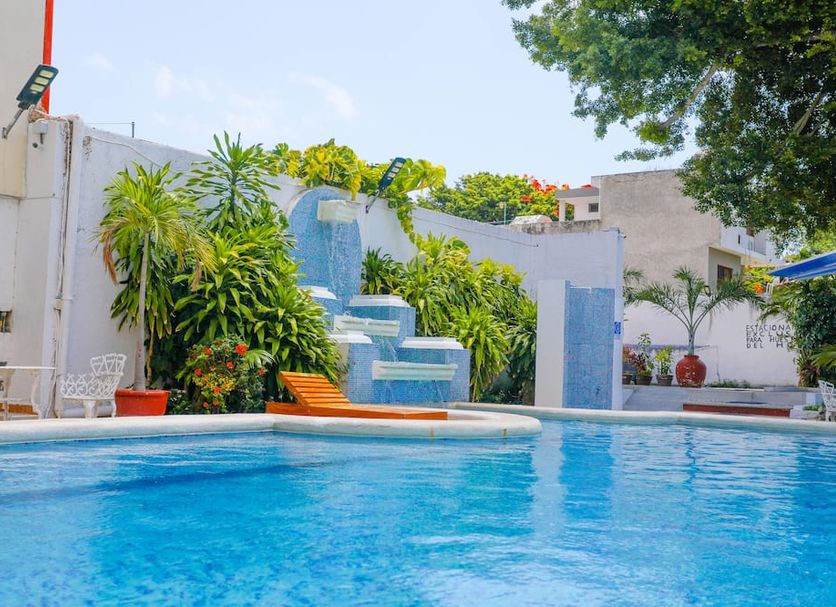 Hotel Maria de Lourdes in Cancún with outdoor pool and tropical waterfall feature