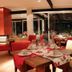 Rio Arriba Suites Apartments y Resto in Bella Vista dining room with red chairs and set tables