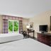 Country Inn & Suites by Radisson Princeton, WV guest room with two beds, desk, TV, and window view
