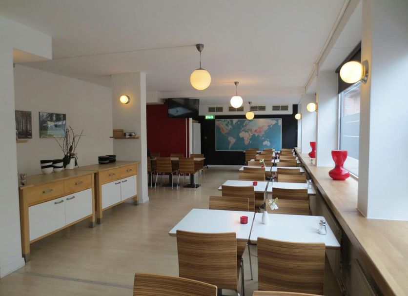 Hotel Göingehof in Hässleholm dining room with long tables, pendant lights and wall map