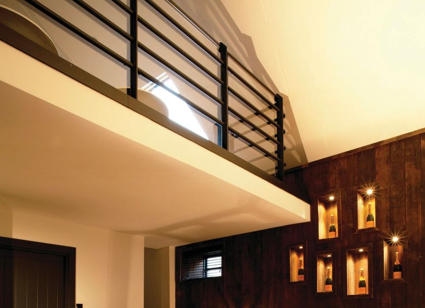 Hotel du Vin Bristol in Bristol room with mezzanine balcony, bed, sofa and wood-paneled wall