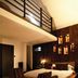 Hotel du Vin Bristol in Bristol room with mezzanine balcony, bed, sofa and wood-paneled wall