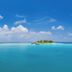 V Villas Maldives at Mirihi - MGallery Collection sailboat on turquoise water near a tropical island