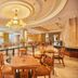 The Royal City Hotel in Bangkok dining room with chandeliers and set tables