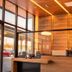 Hotel Mirage Brooklyn lobby reception with wood-paneled walls and large glass windows in Brooklyn