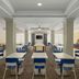 Breakfast room at City Express by Marriott Washington, DC Northeast with tables, blue chairs, and buffet stations.