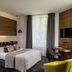 Chateau de Saulon guest room in Saulon-la-Rue with double bed, desk, TV and tall window