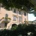 Albergo Michieletto in Montano Lucino, peach-colored hotel facade with arched windows and flower boxes