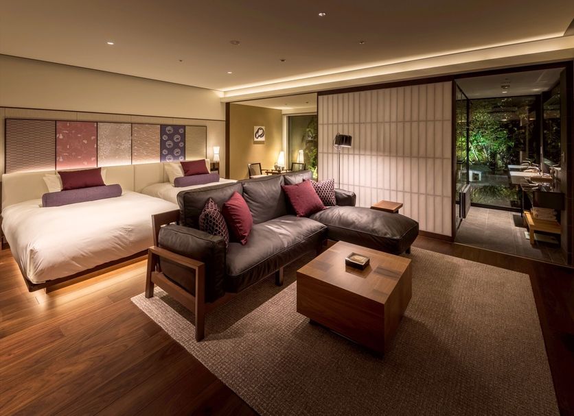 Solaria Nishitetsu Hotel Kyoto Premier guest room with twin beds, sofa, and garden-view sliding doors