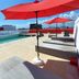 In Fashion Hotel & Spa rooftop pool with red umbrellas and lounge chairs in Playa del Carmen