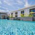 The Rubber Hotel (Sha Plus+) in Thep Krasattri with outdoor pool and modern low-rise building