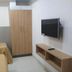Abirami Inn Kumbakonam guest room with twin beds, wardrobe, and wall-mounted TV