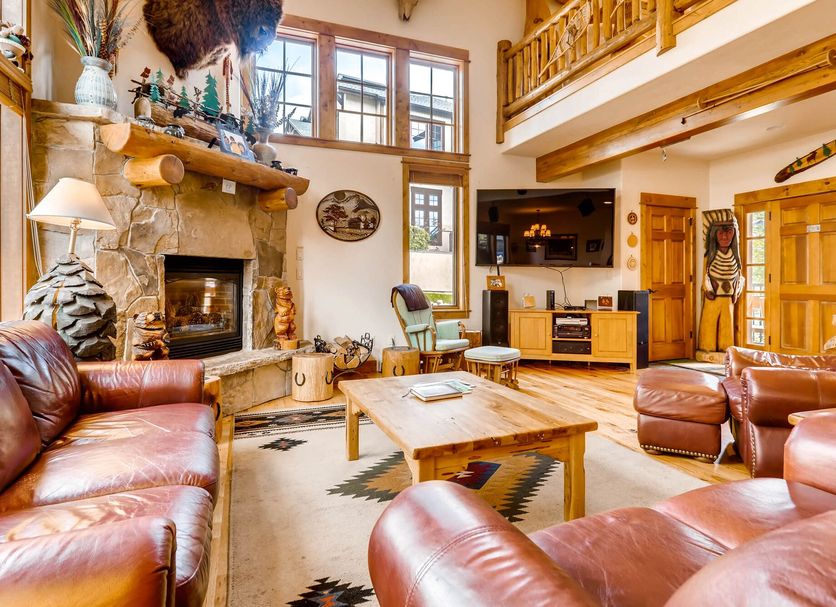 Eagleridge Lodge & Townhomes in Steamboat Springs living room with stone fireplace and loft seating