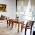 Hotel Rockaway in Puerto Escondido guest room with wooden table, chairs and ocean-view balcony doors