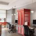 Home2 Suites by Hilton Alexandria workspace with desks, computers and red storage cabinet