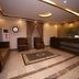 Zifan Hotel & Suites lobby in Karachi with front desk, seating area and patterned rug