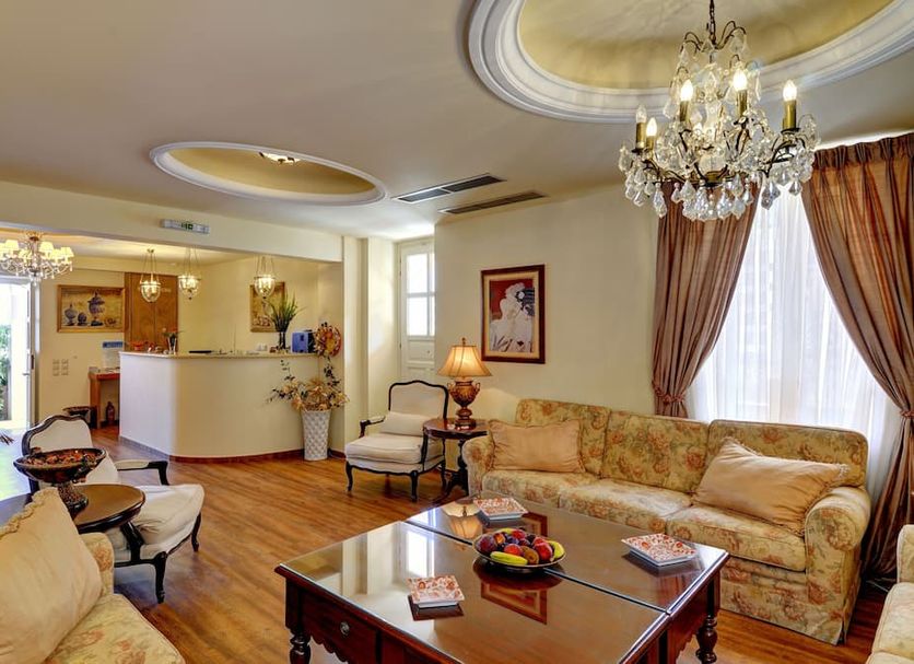 Korina Gallery Hotel Vathy lobby lounge with chandelier, glass coffee table and sofa