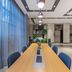 Home Inn Suzhou Mudu Ancient Town Lingyanshan Metro Station meeting room with long table and blue chairs in Suzhou