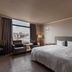 Hotel j-Metropolis in Hsinchu City guest room with king bed, window view, and seating area