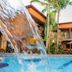 Tiradentes Village in Tiradentes with pool, palm trees, and waterfall feature in a courtyard setting