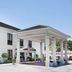 Baymont by Wyndham Savannah/Garden City in Savannah, exterior entrance with covered portico and parked cars