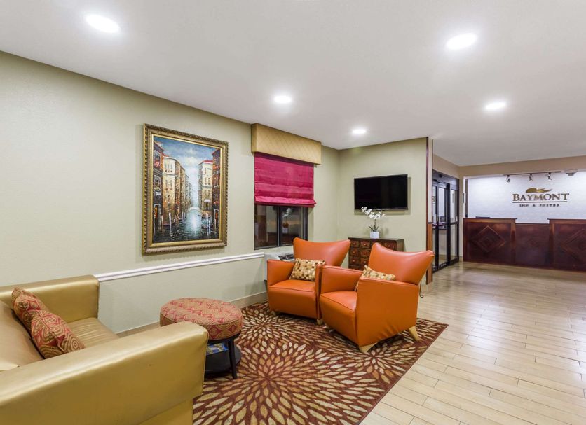 Baymont by Wyndham Savannah/Garden City lobby seating area with TV and front desk in Savannah