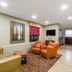 Baymont by Wyndham Savannah/Garden City lobby seating area with TV and front desk in Savannah