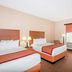 Baymont by Wyndham Savannah/Garden City in Savannah guest room with two beds and a window desk