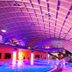 Hotel an der Therme Bad Orb indoor pool with curving ceiling and colorful purple lighting in Bad Orb