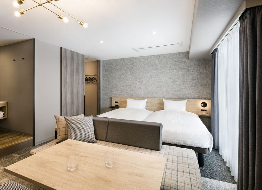 Tokyu Stay Shibuya room in Tokyo with king bed, sofa, and large window