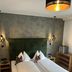 Hotel Sunshine Superior - Adults Only in Kappl: cozy twin bed with green headboard and pendant lights
