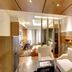 Hotel Grand Marian in Ludhiana, modern suite with seating area, partitioned bed space, and warm wood ceiling