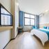 Zhoushan Dinghai New Donggang Hotel guest room with bed, desk and city view in Zhoushan