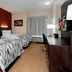 Red Roof Inn Raleigh Southwest - Cary room with two beds, desk, TV, and window seating in Cary