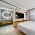 Orange Hotel Hangzhou Wulin Square Moganshan Road guest room with bed, TV and vanity in Hangzhou