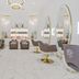The Adelphi Hotel in Saratoga Springs salon with oval mirrors, gold chairs, and white marble-style floors