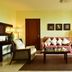 Pestana São Tomé lounge with sofa, armchairs, coffee table and window with curtains