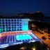 Grand Zaman Beach Hotel in Alanya with lit outdoor pool and sea view at night