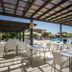Club Belambra Le Vidourle in Le Grau-du-Roi: shaded outdoor terrace with poolside dining tables and chairs