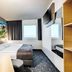B&B Hotel Bonn-West room with double bed, wall art, TV and window view in Bonn