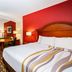 La Quinta Inn & Suites by Wyndham North Platte guest room with king bed and sitting area