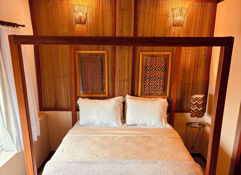 Boutique Hotel Casa Teatro in Manaus guest room with four-poster bed and colorful stools