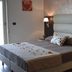 Miramare Scilla Gyh Luxury guest room with two beds, bedside lamps, and a padded headboard in Scilla
