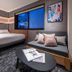 Hotel Graphy Shibuya room in Tokyo with bed, sofa daybed, and city view through large window