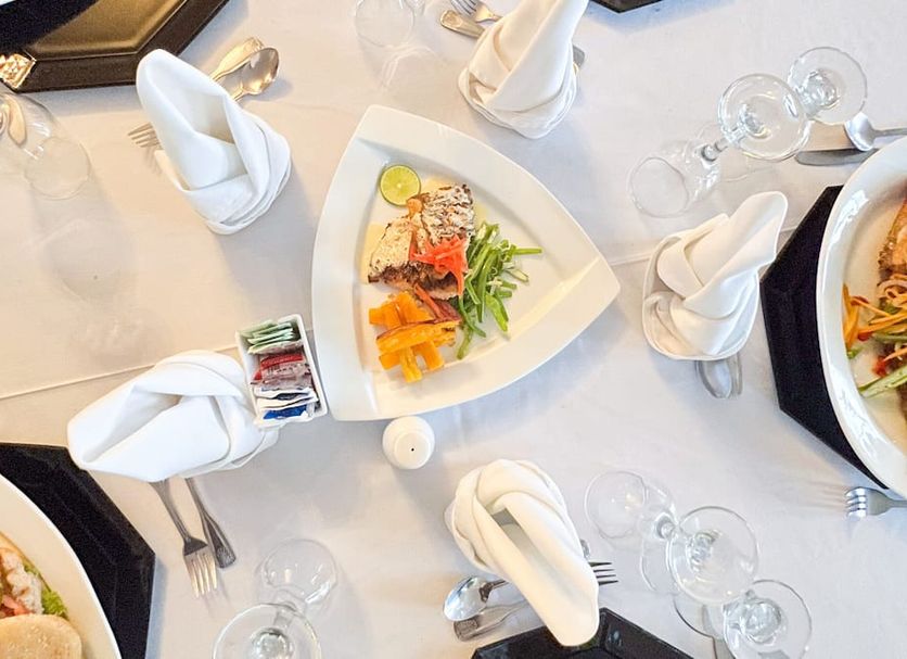 Jamaica Palace Hotel, Port Antonio: elegant banquet table with plated salad, folded napkins and glassware