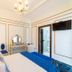 Casa Nostra Boutique Hotel, Paraty: elegant room with blue bed, ornate mirror, and wall-mounted TV