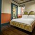 The July - Boat & Co in Amsterdam, cozy guest room with patterned bed, window view, and bathroom doorway