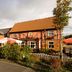 Premier Inn Warrington Central North in Warrington, with a roadside exterior and outdoor seating area