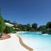 Ostuni a Mare in Ostuni featuring a curving outdoor pool with lounge chairs and lush greenery